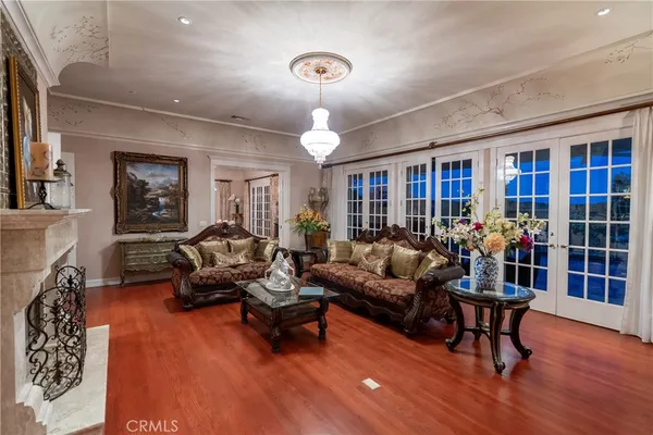 a living room with furniture a chandelier and a dining room