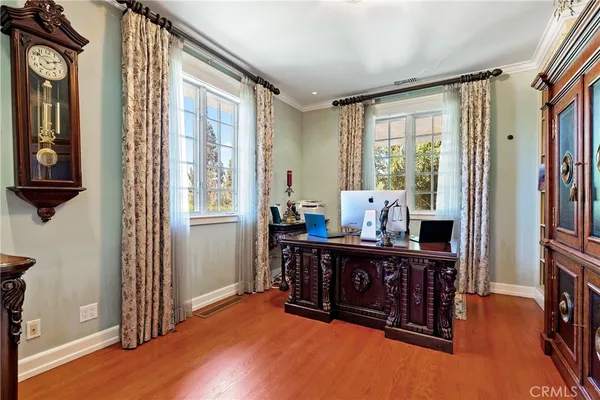 a bedroom with furniture and a wooden floor