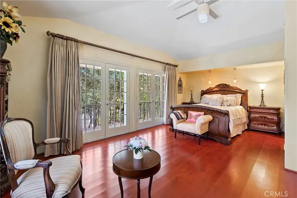 a bedroom with a bed wooden floor and window