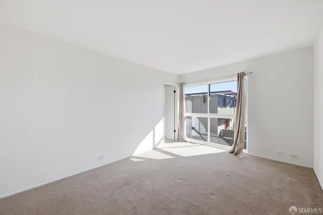a view of an empty room and a window