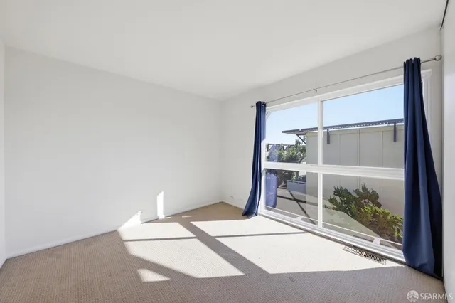 a view of a balcony with wooden floor and fence