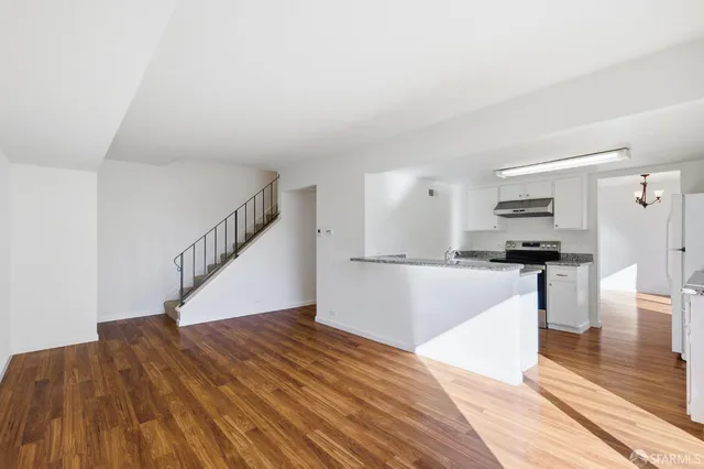 a view of kitchen with sink and refrigerator