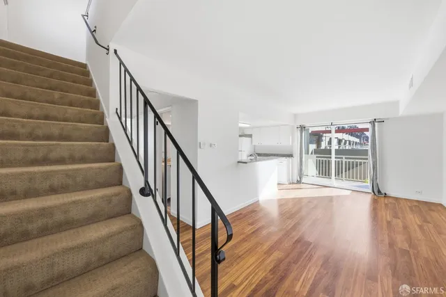 a view of entryway and hall with wooden floor