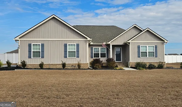 a front view of a house with a yard