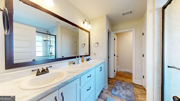 a spacious bathroom with a double vanity sink mirror and double