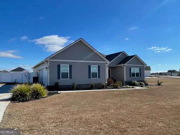 a front view of a house with a yard