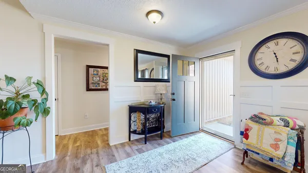 a view of a hallway with entryway wooden floor and a dining room