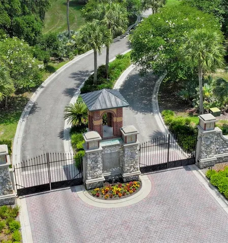 a backyard of a house with fountain table and chairs