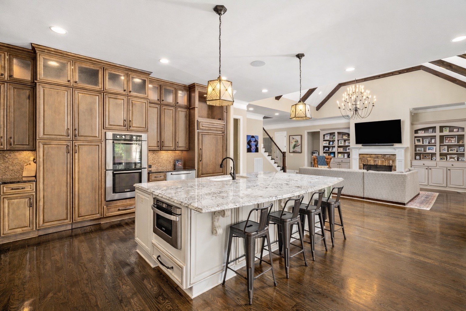 400 Ernest Rice Lane Franklin, TN 37069 - Photo 30 of 62 a large kitchen with stainless steel appliances kitchen island granite countertop a table chairs and a refrigerator