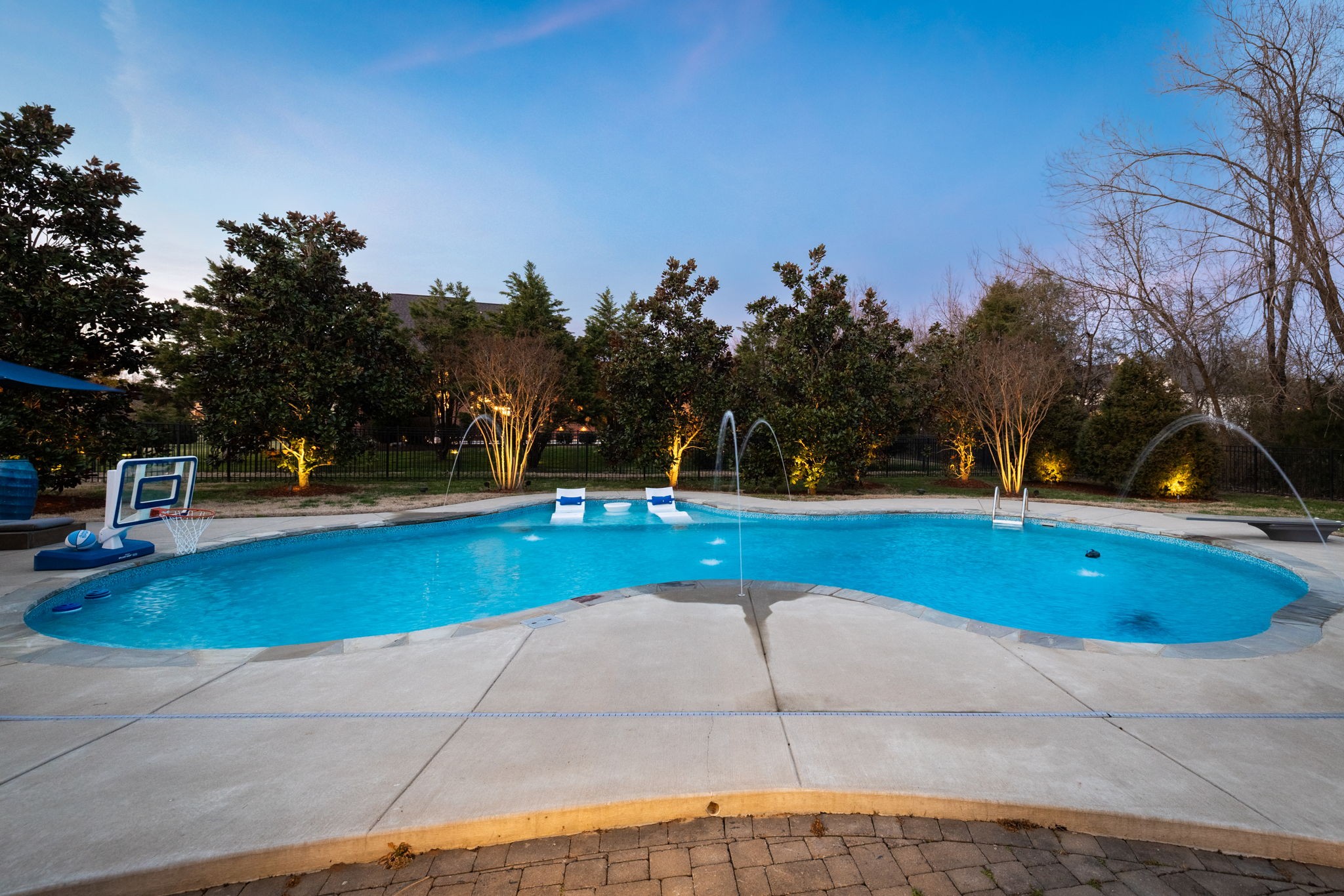 400 Ernest Rice Lane Franklin, TN 37069 - Photo 8 of 62 a view of swimming pool with outdoor seating and trees in the background