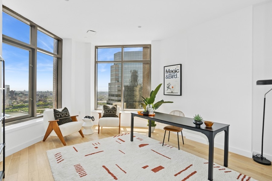 75 Wall Street, Unit PHD2 Manhattan, NY 10005 - Photo 10 of 15 a living room with furniture and a large window