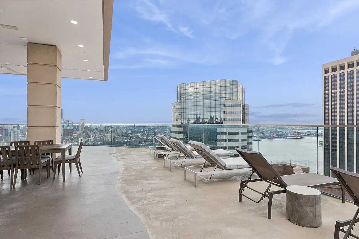75 Wall Street, Unit PHD2 Manhattan, NY 10005 - Photo 13 of 15 a living room with couches a coffee table and chairs with the view of kitchen
