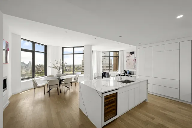 a living room with furniture and floor to ceiling windows