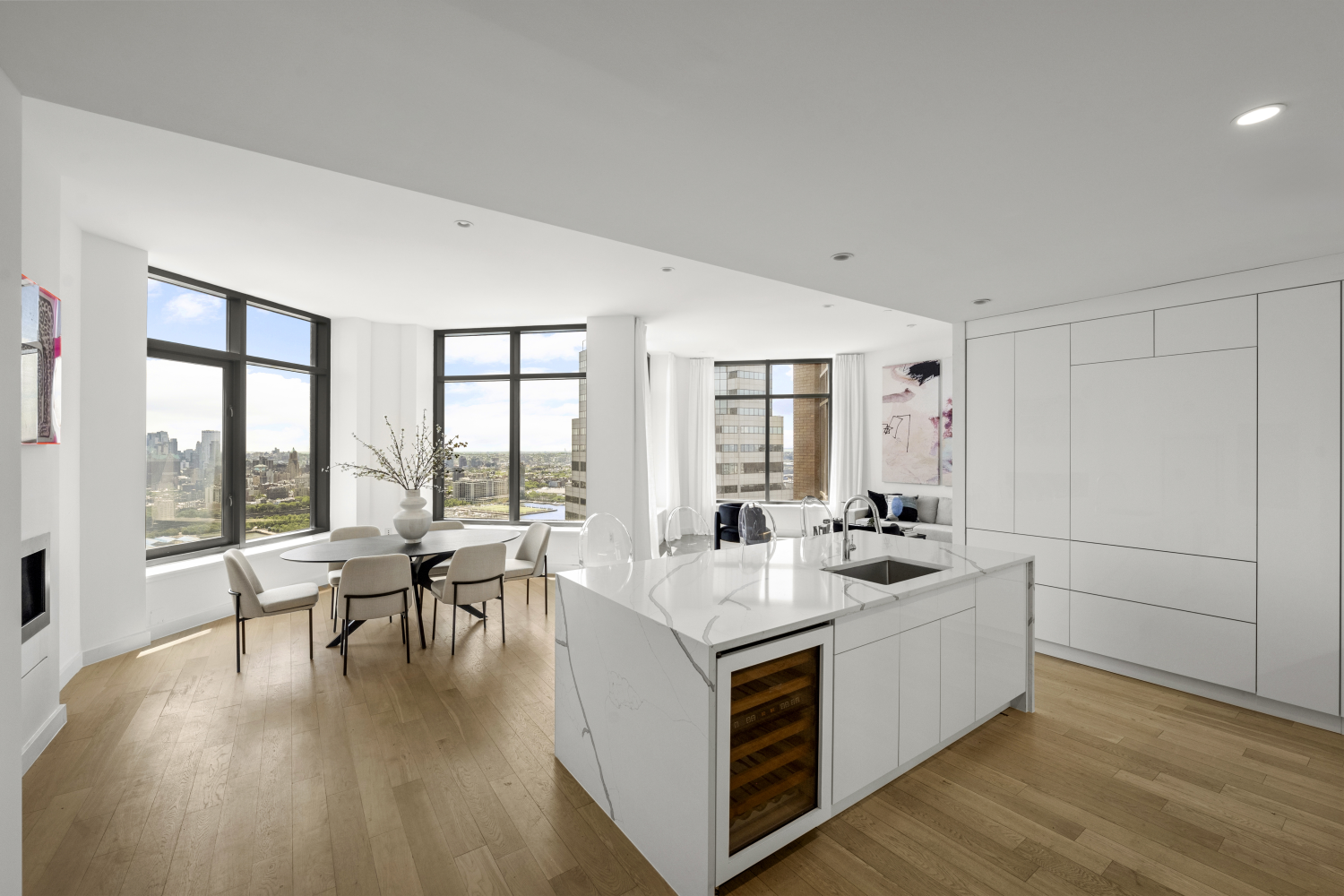 a living room with furniture and floor to ceiling windows