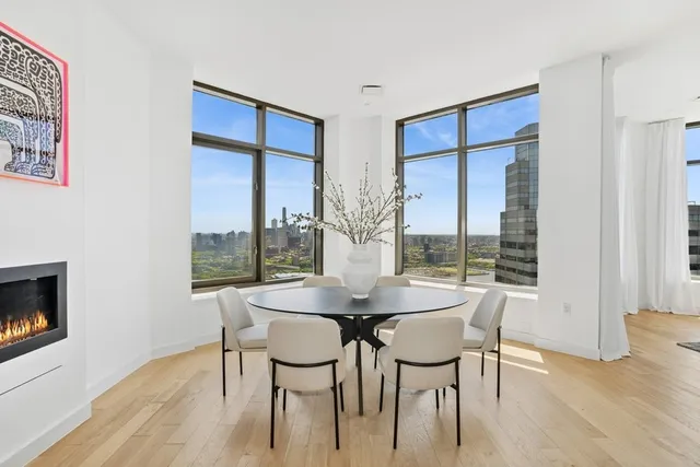 a dining room with furniture and wooden floor