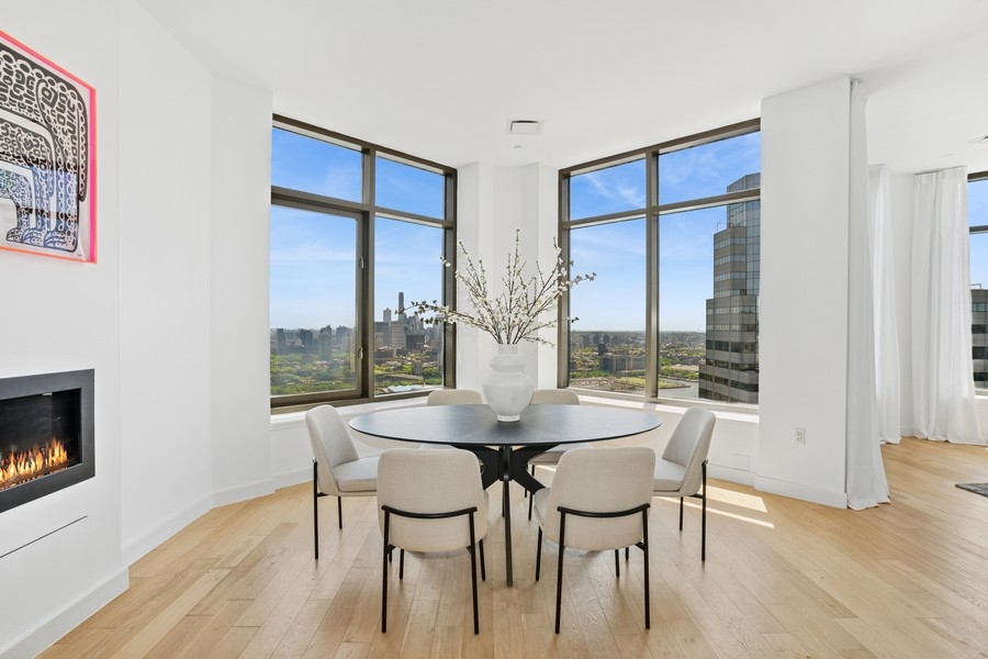 75 Wall Street, Unit PHD2 Manhattan, NY 10005 - Photo 2 of 15 a dining room with furniture and wooden floor
