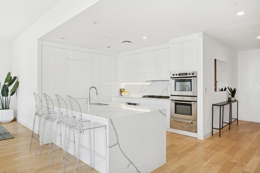 75 Wall Street, Unit PHD2 Manhattan, NY 10005 - Photo 5 of 15 a kitchen with appliances a sink and cabinets