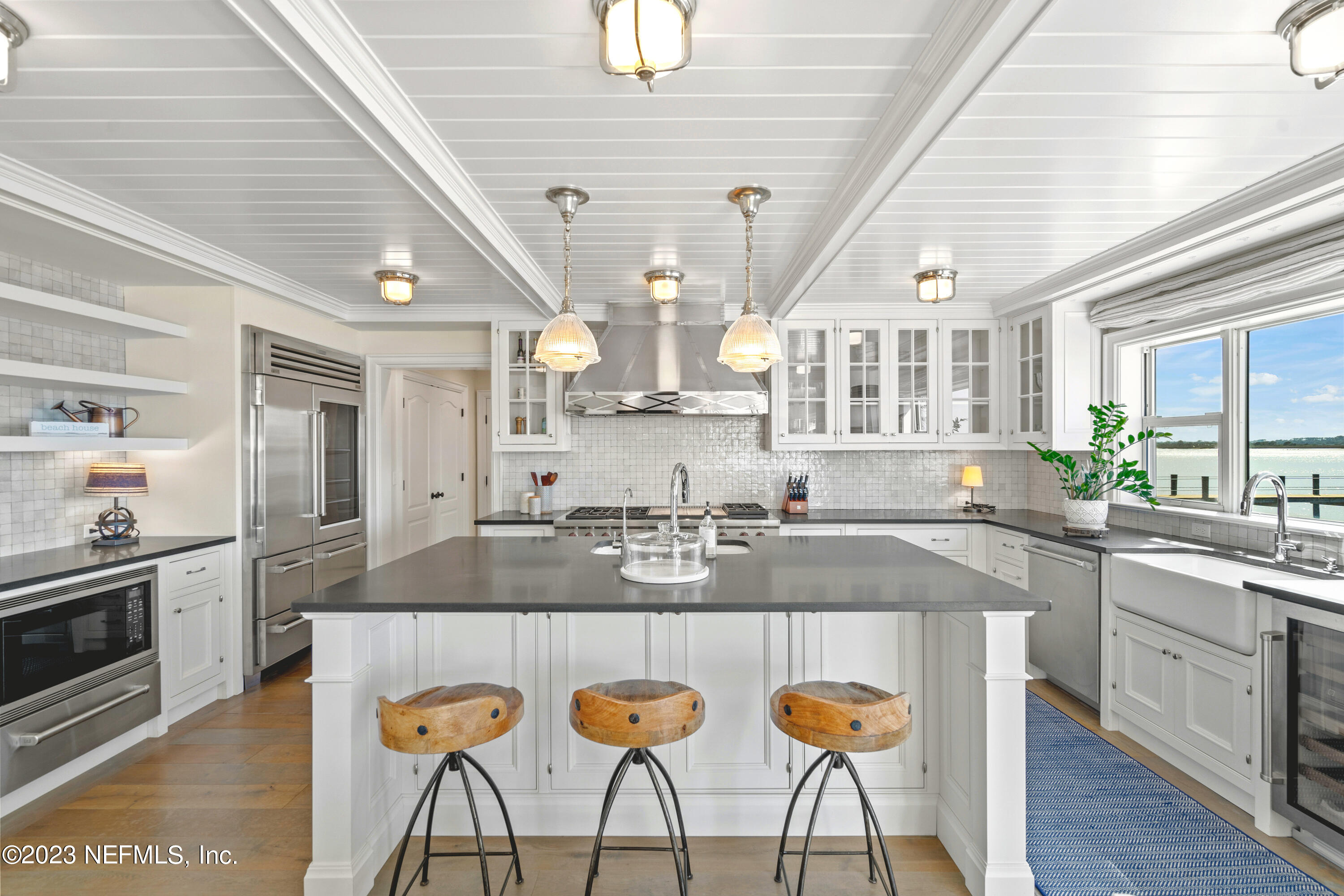 500 North Point Road St. Augustine, FL 32084 - Photo 19 of 102 a kitchen with stainless steel appliances granite countertop a kitchen island a stove a sink dishwasher and cabinets with wooden floor