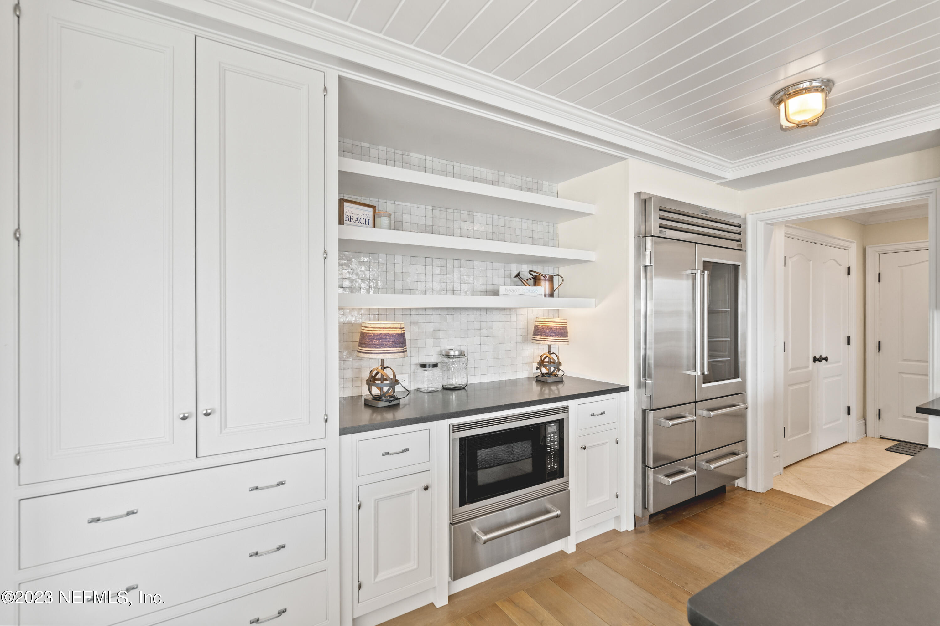 500 North Point Road St. Augustine, FL 32084 - Photo 22 of 102 a kitchen with white cabinets and white appliances