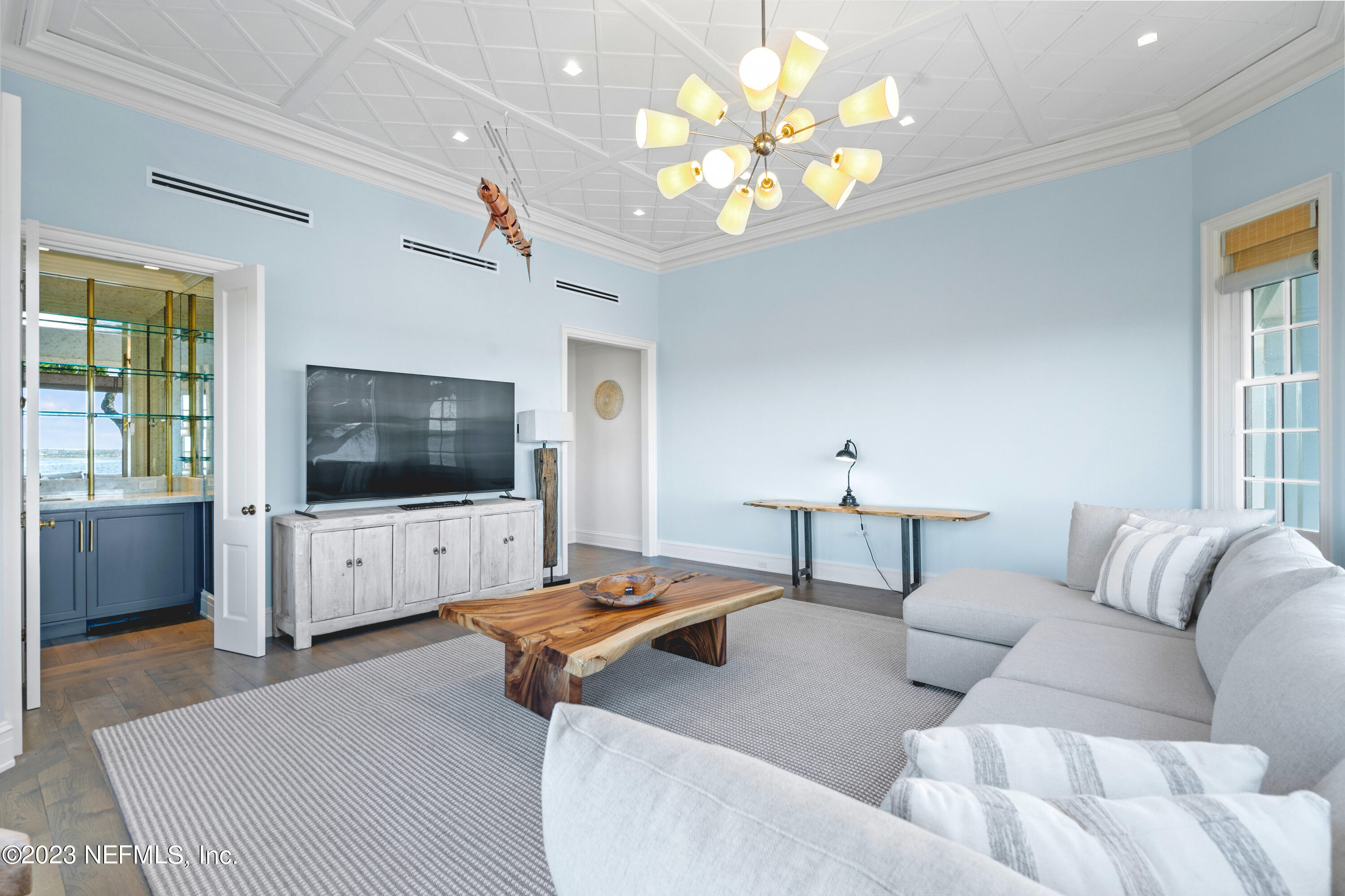 500 North Point Road St. Augustine, FL 32084 - Photo 33 of 102 a living room with furniture a flat screen tv and a chandelier
