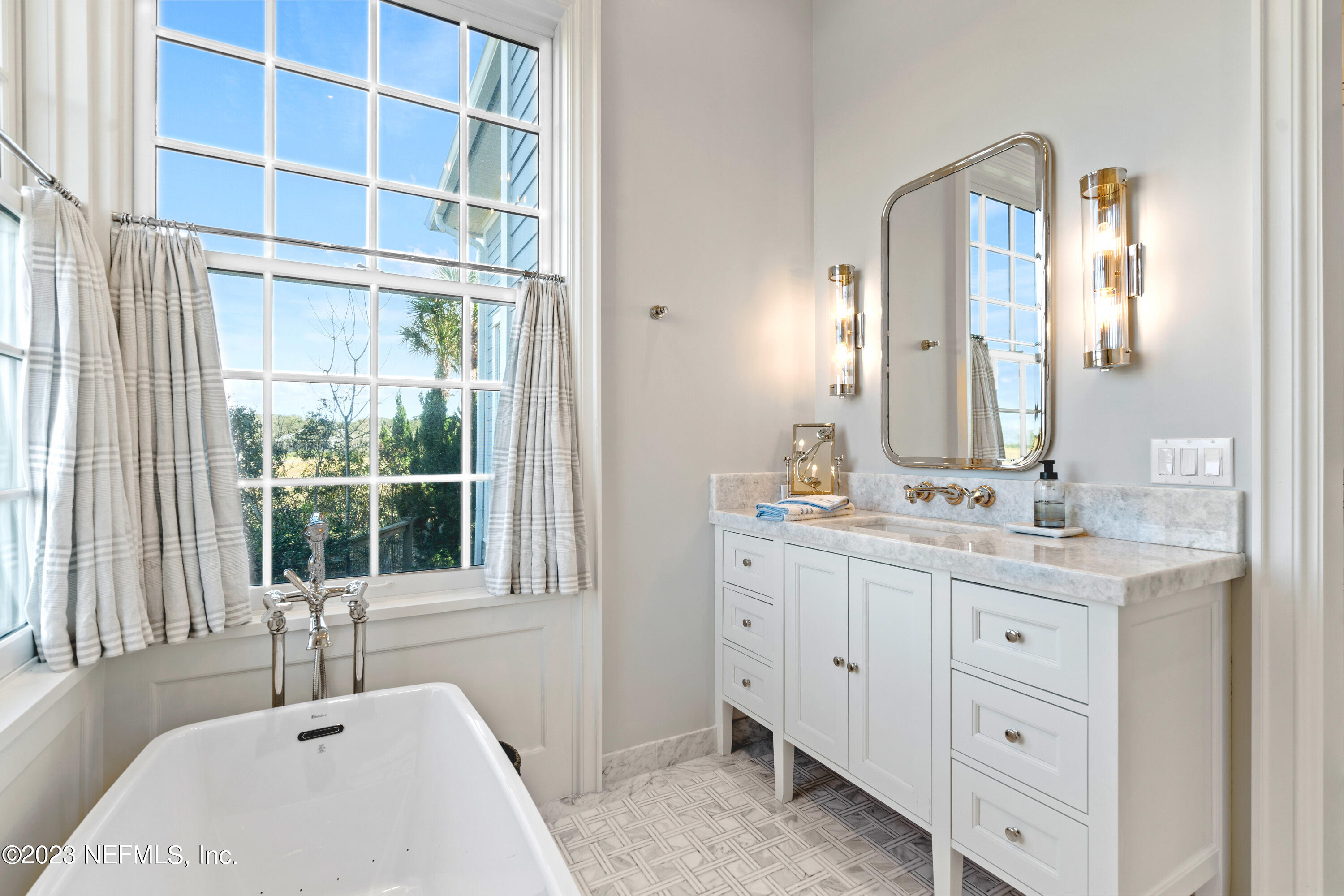 500 North Point Road St. Augustine, FL 32084 - Photo 35 of 102 a bathroom with a double vanity sink and a large mirror
