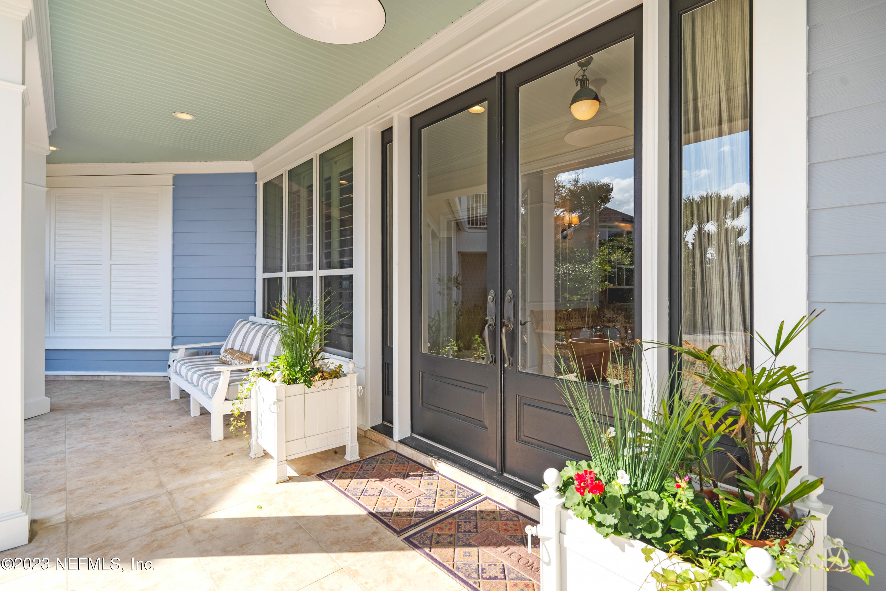 500 North Point Road St. Augustine, FL 32084 - Photo 4 of 102 a front view of a house with a potted plant and floor to ceiling window