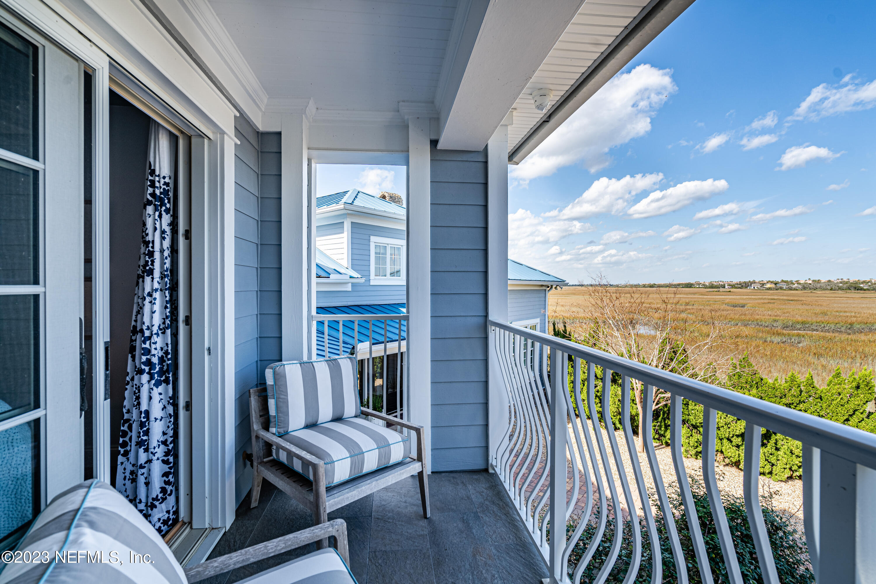500 North Point Road St. Augustine, FL 32084 - Photo 55 of 102 a view of a balcony with chair and floor to ceiling window