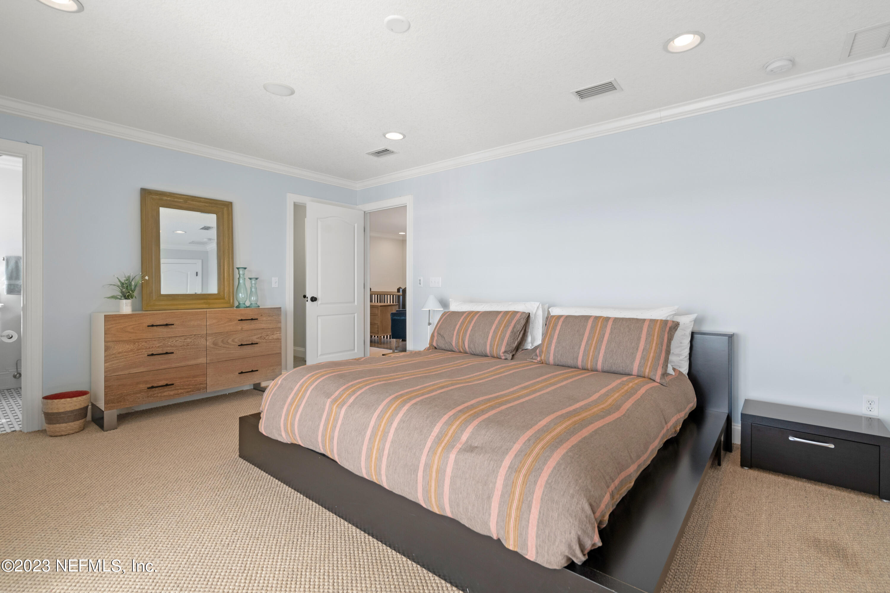 500 North Point Road St. Augustine, FL 32084 - Photo 62 of 102 a bedroom with a bed and a dresser