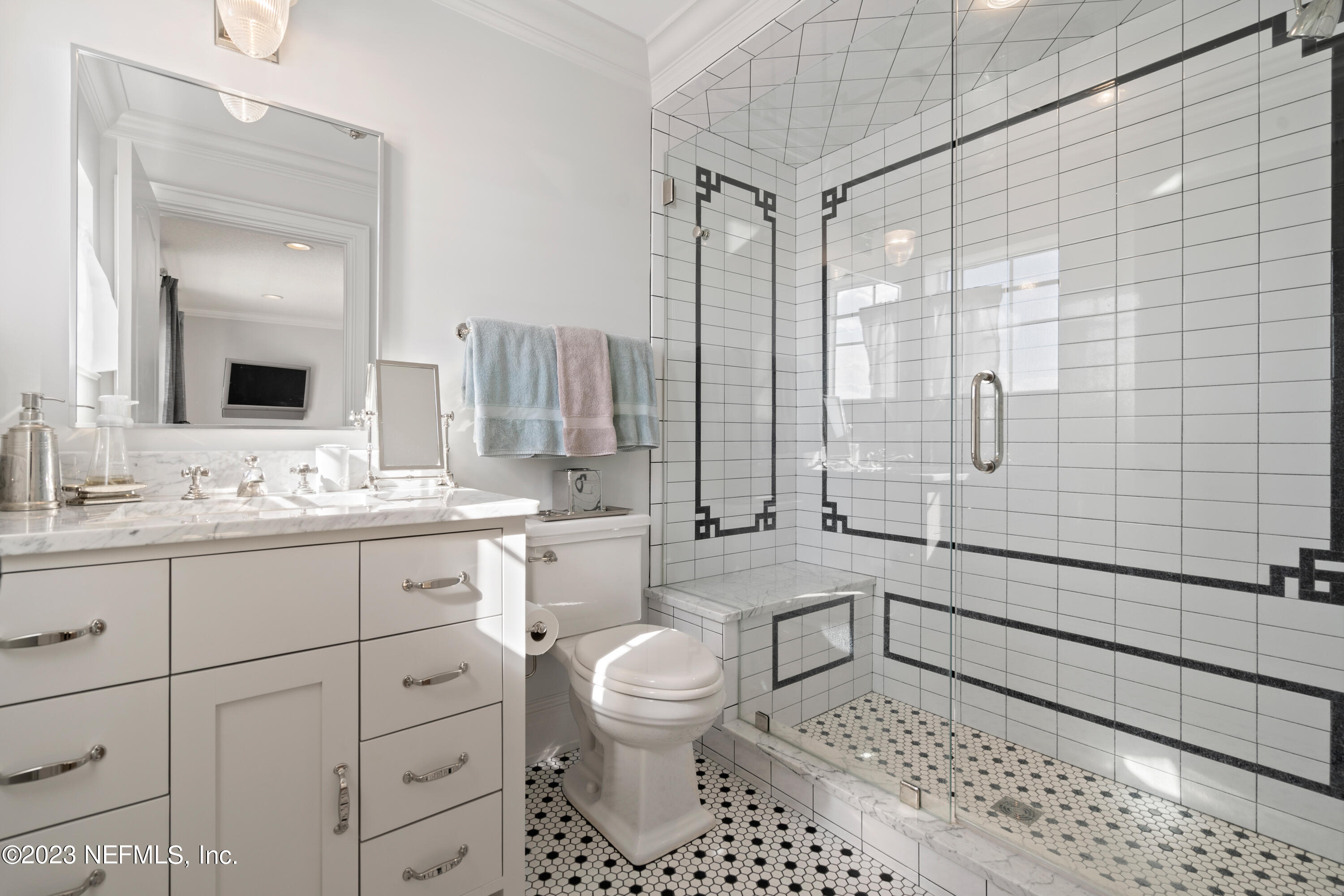 500 North Point Road St. Augustine, FL 32084 - Photo 63 of 102 a bathroom with a double vanity sink toilet mirror and shower