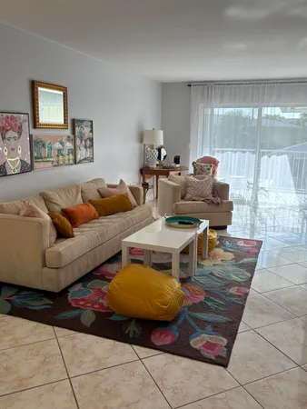 a living room with furniture and a glass door