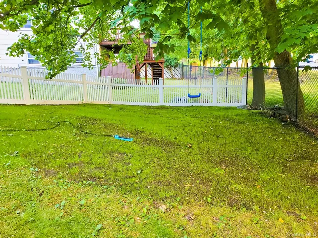 a view of a house with a yard and sitting area