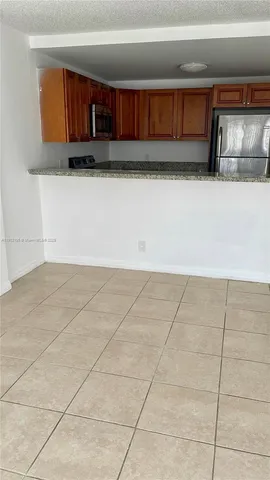 a view of kitchen with cabinets