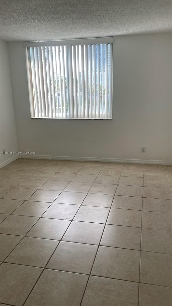 9143 Southwest 77th Avenue, Unit B505 Miami, FL 33156 - Photo 3 of 6 a view of an empty room and window