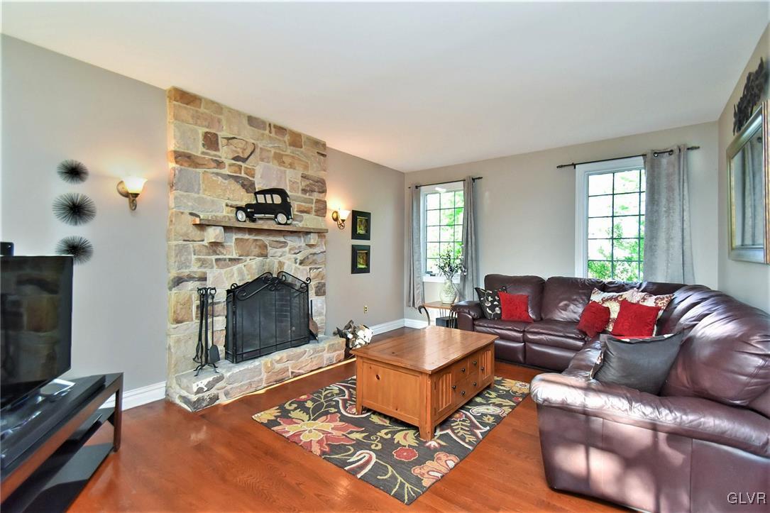 215 Klein Road Bath, PA 18014 - Photo 17 of 44 a living room with furniture a flat screen tv and a fireplace
