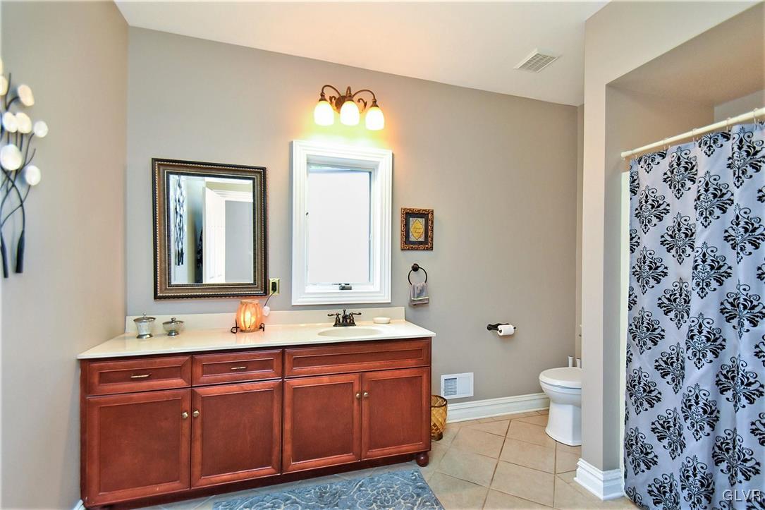 215 Klein Road Bath, PA 18014 - Photo 21 of 44 a bathroom with a double vanity sink toilet and a mirror