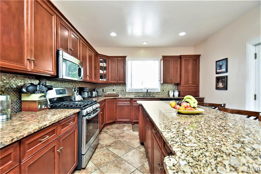 215 Klein Road Bath, PA 18014 - Photo 6 of 44 a kitchen with stainless steel appliances granite countertop a stove sink and cabinets