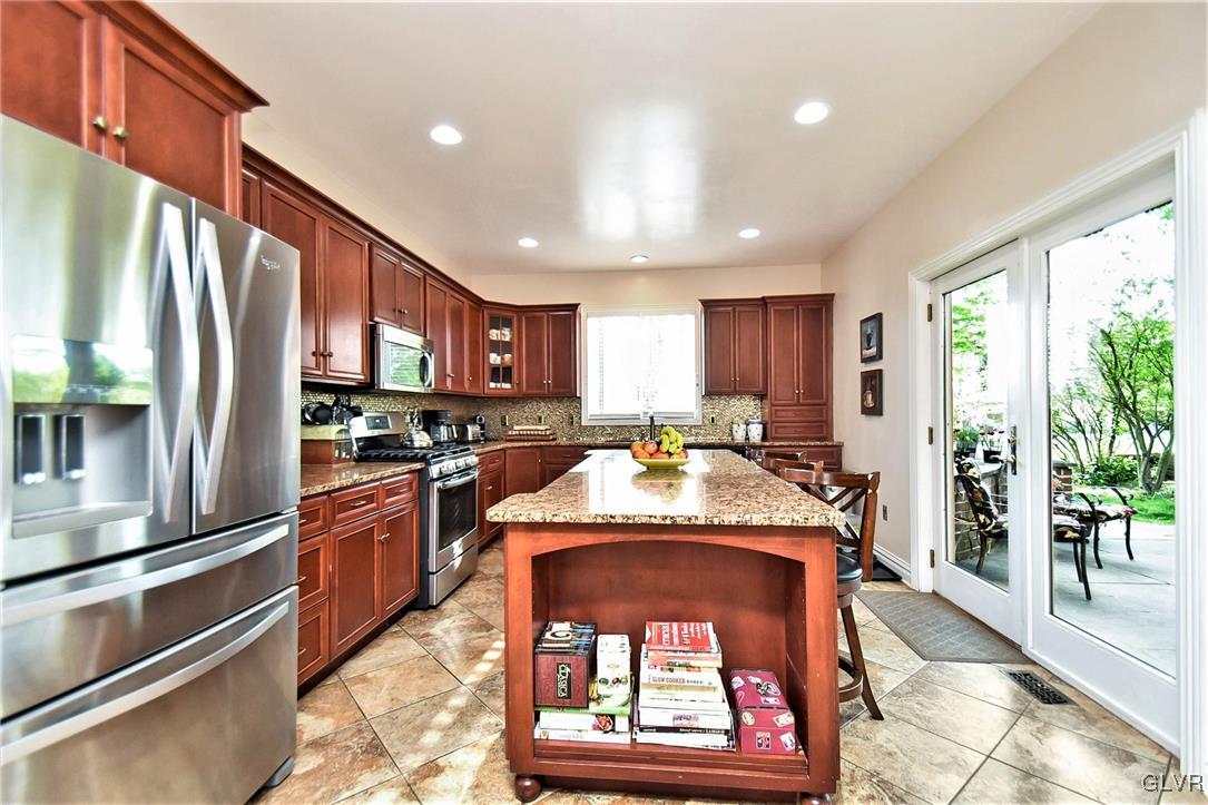 215 Klein Road Bath, PA 18014 - Photo 9 of 44 a kitchen with stainless steel appliances granite countertop a refrigerator a stove top oven a sink and a large window