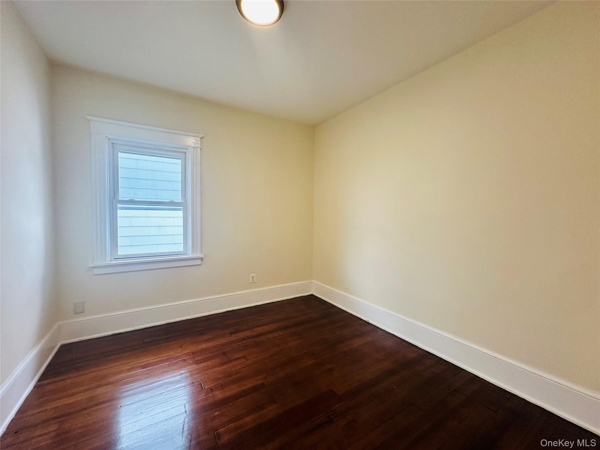 71 North Hamilton Street Poughkeepsie, NY 12601 - Photo 8 of 15 a view of an empty room with wooden floor and a window