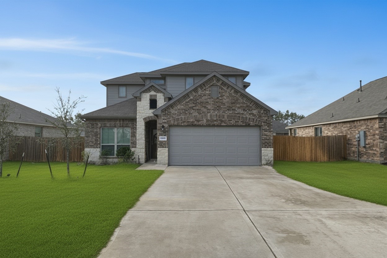 a front view of a house with a yard and trees