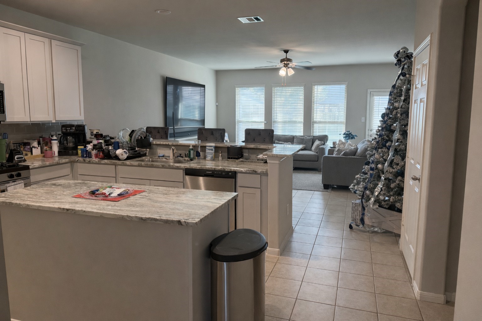 26016 Babe Ruth Drive Splendora, TX 77372 - Photo 8 of 11 a kitchen with a sink a stove and chairs