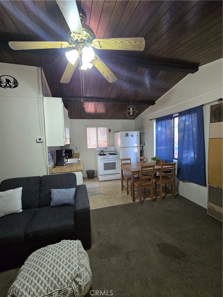 312 Riverside Avenue Big Bear City, CA 92386 - Photo 14 of 22 a living room with furniture and a chandelier