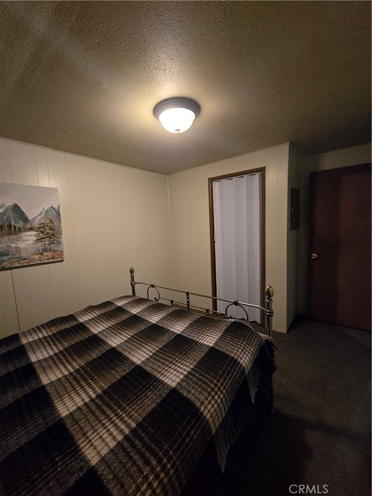 312 Riverside Avenue Big Bear City, CA 92386 - Photo 17 of 22 a bed sitting in a room next to a window