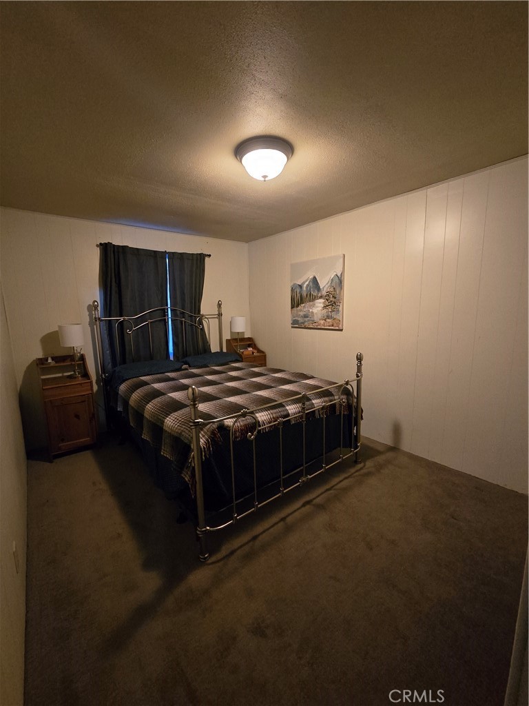 312 Riverside Avenue Big Bear City, CA 92386 - Photo 18 of 22 a bedroom with a bed and a night stand
