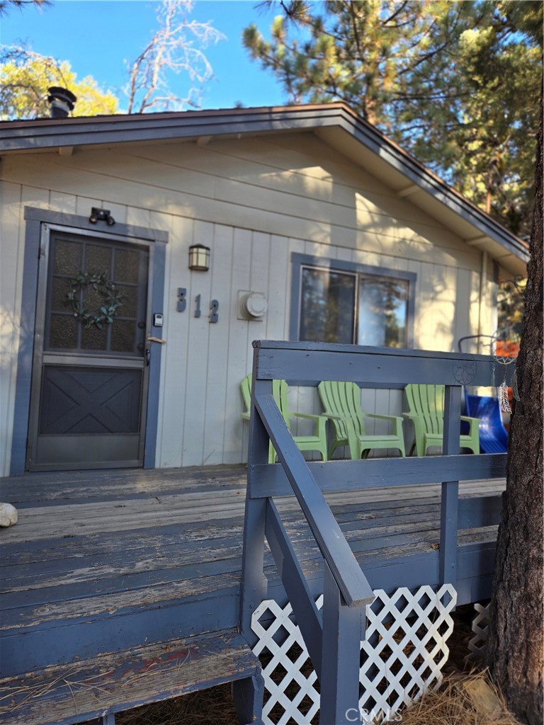 312 Riverside Avenue Big Bear City, CA 92386 - Photo 2 of 22 a front view of a house with a garden