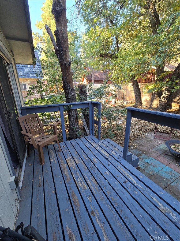 312 Riverside Avenue Big Bear City, CA 92386 - Photo 8 of 22 a view of balcony with wooden floor and outdoor seating