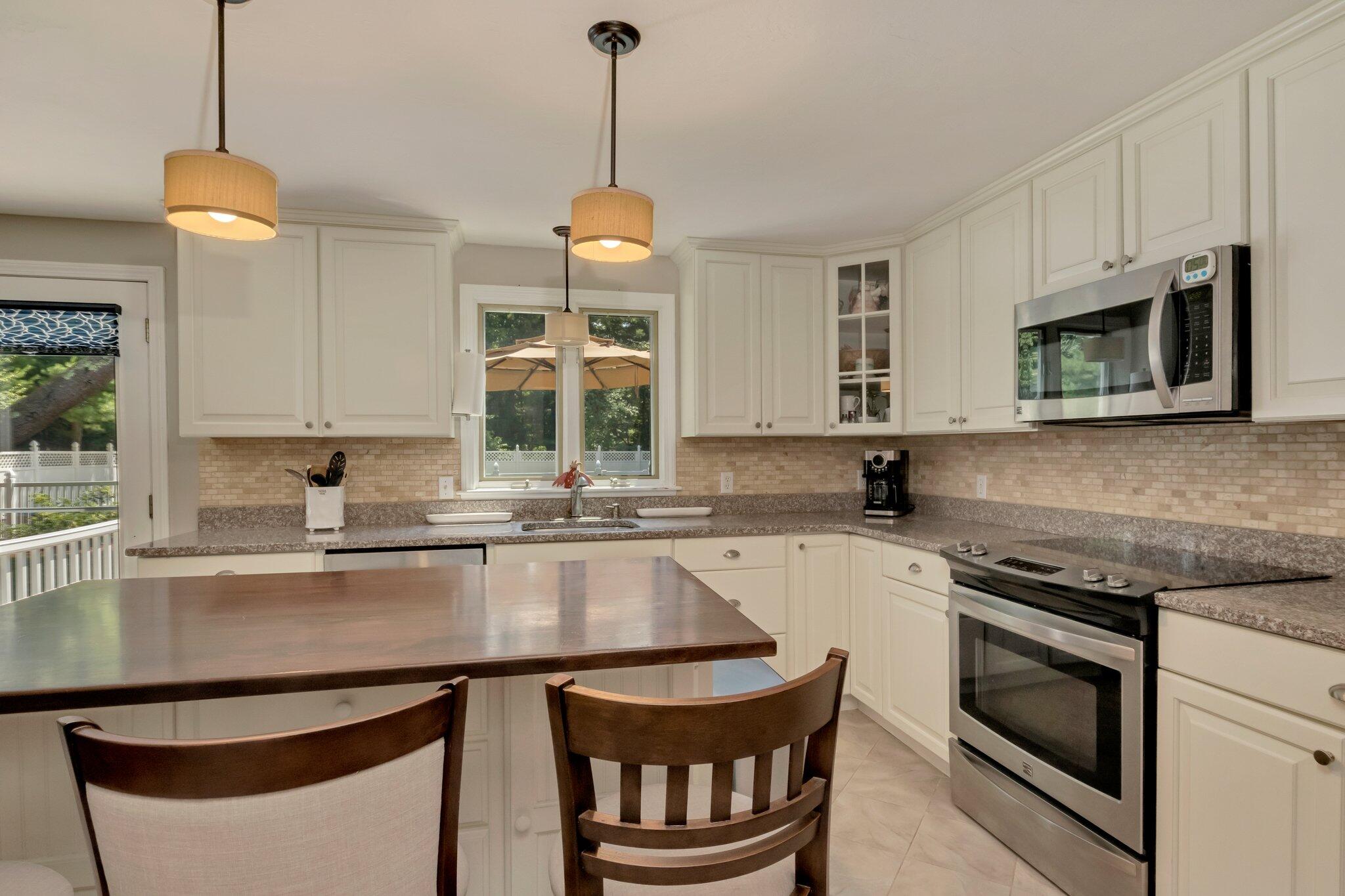 10 Nye Road Centerville, MA 02632 - Photo 11 of 66 a kitchen with stainless steel appliances granite countertop a stove a sink and a microwave