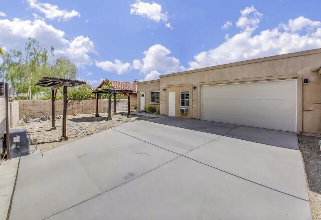 53860 Avenida Herrera, Unit A La Quinta, CA 92253 - Photo 3 of 9 a view of a street with a building in the background