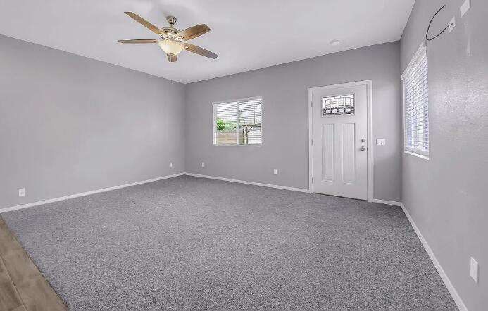 53860 Avenida Herrera, Unit A La Quinta, CA 92253 - Photo 5 of 9 an empty room with windows and fan