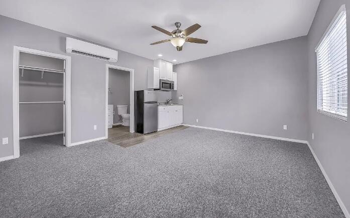 53860 Avenida Herrera, Unit A La Quinta, CA 92253 - Photo 6 of 9 a view of a livingroom with a ceiling fan and window
