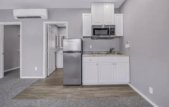 a kitchen with cabinets and stainless steel appliances